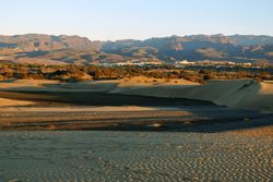 Picturesque sandy valley with distant exotic town