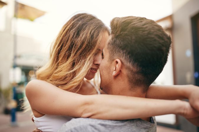 Woman with arms around her boyfriend