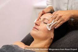 Woman having face cleansed during facial 426kw1