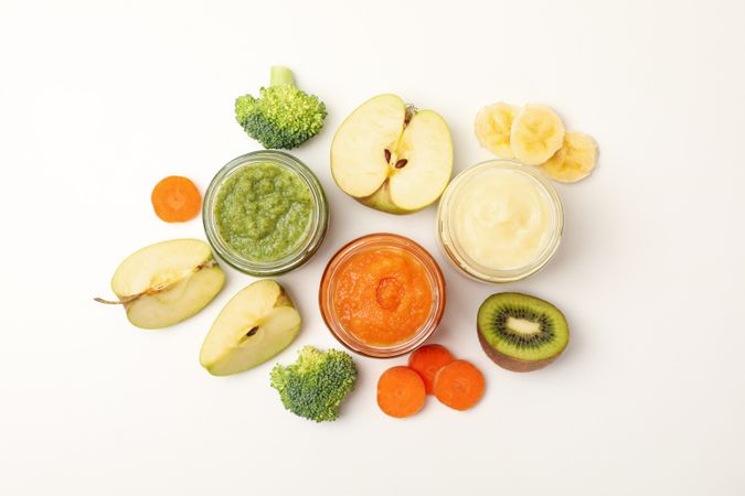 Composition with baby food on plain background. Vegetable puree