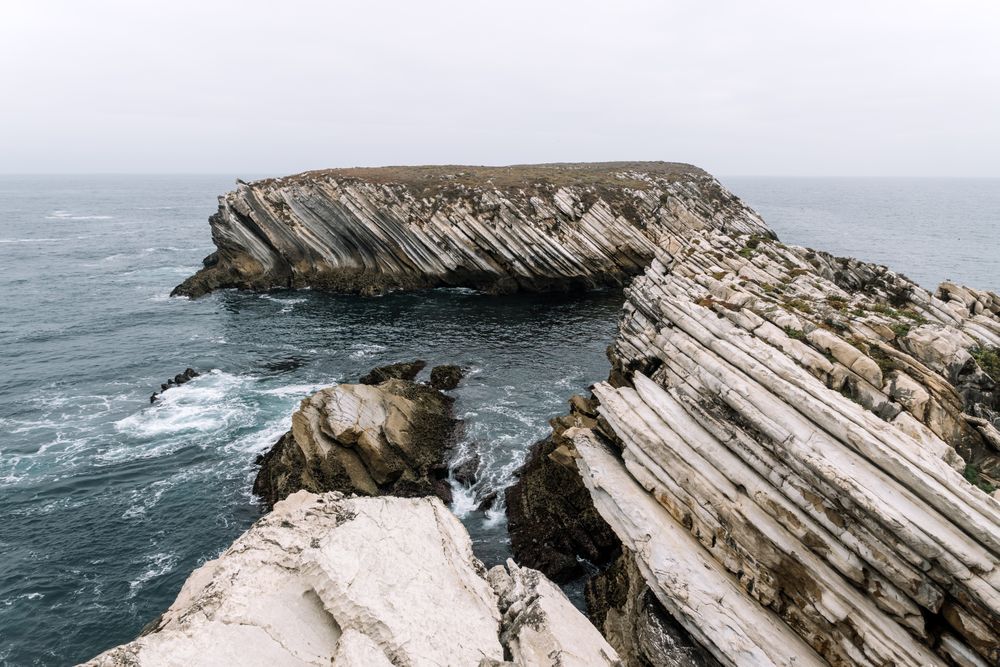 Rocky formations in the island of Baleal on the Atlantic coast in a foggy day. Peniche, Portugal