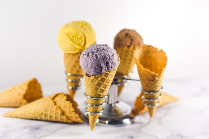 Ice cream cone holder with waffle cones and three different scoops