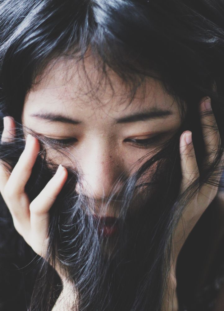 Portrait of woman covering her face with her hair