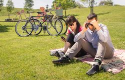 Couple in love using a smartphones on the park