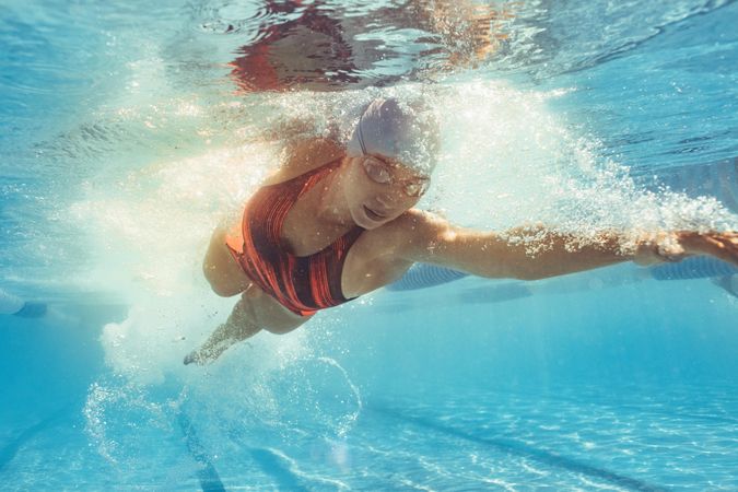 Fit female athlete practicing in swimming pool