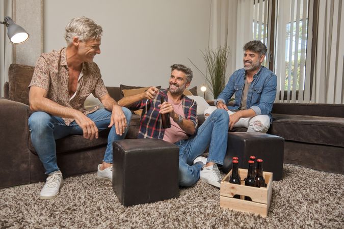 Adult brothers drinking beer with father