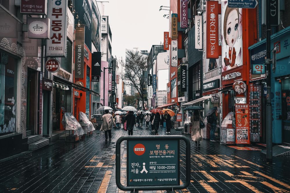 People walking down an alley in a busy area in East Asia