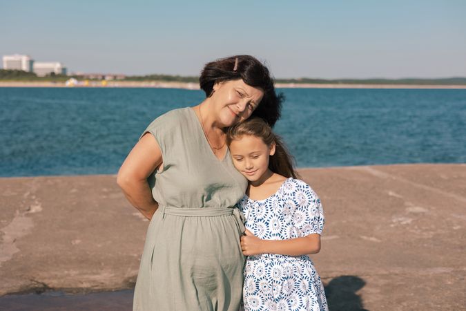 Grandmother and granddaughter by the sea