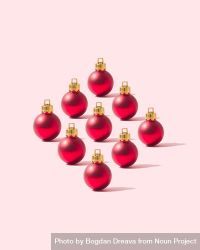 Nine red round ornaments on pink background bx9va0