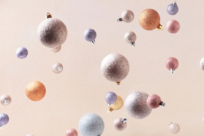 Pastel Christmas baubles on beige background