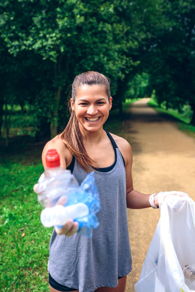 Woman showing garbage she has collected