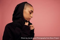 Female with shaved head on pink background 0VPGv4