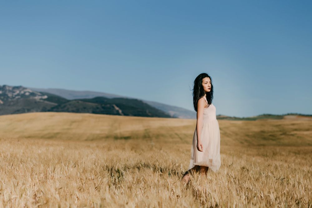 Model standing in field with copy space