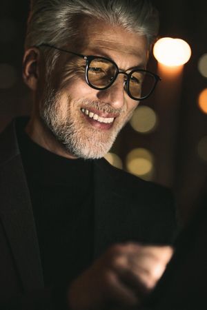 Close up of smiling businessman using digital tablet in office