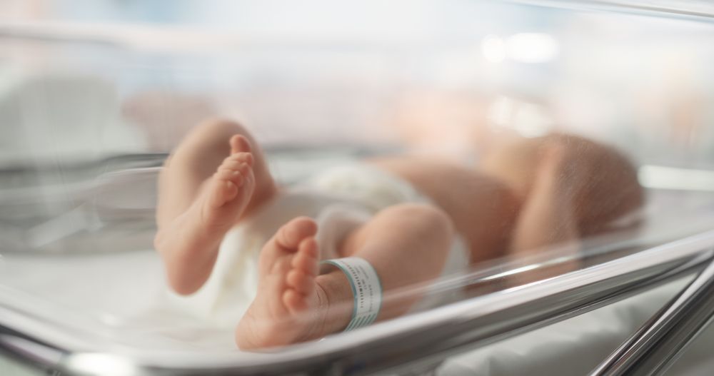 Cute Little Newborn Baby Lying in Bassinet in a Maternity Hospital.