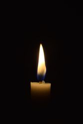 Side view of candle flame in the dark