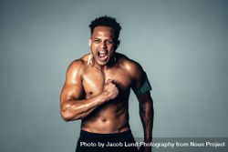 Shirtless male model with muscular physique shouting 41ljND