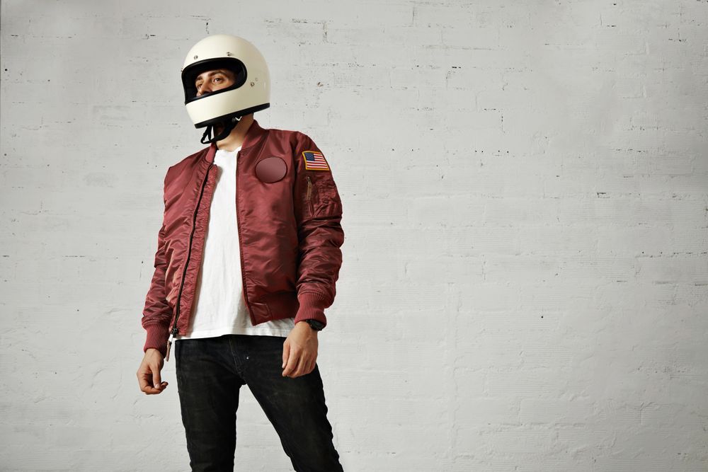 Man in dark red leather jacket and biker helmet