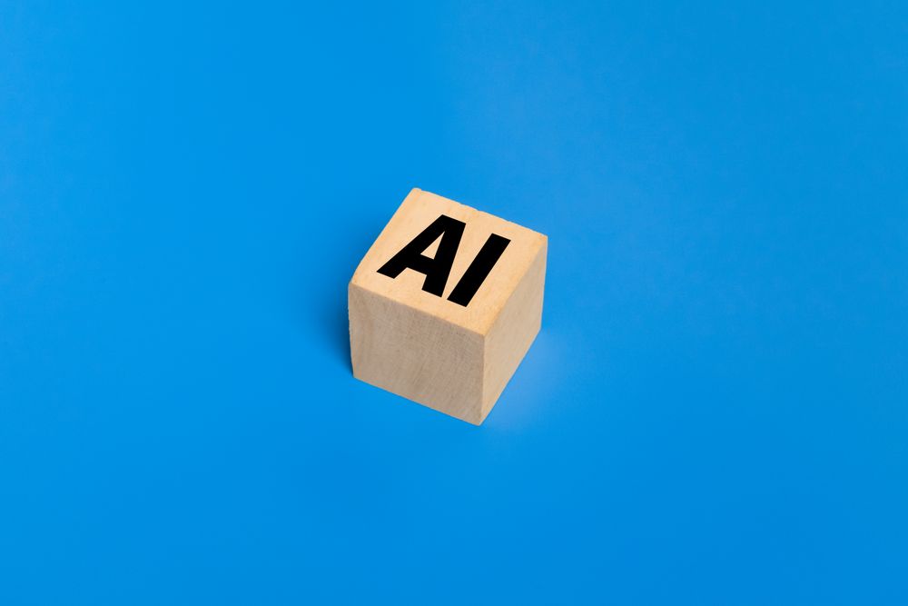 AI symbol or artificial intelligence on wooden blocks. isolated on blue background