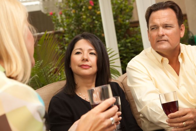 Three Friends Enjoying Wine on the Patio