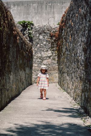 Girl in narrow stone walkway