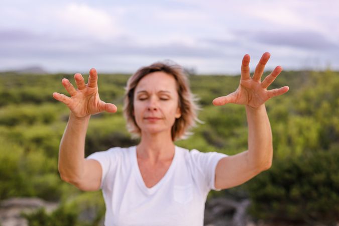 Adult woman practicing martial arts in nature