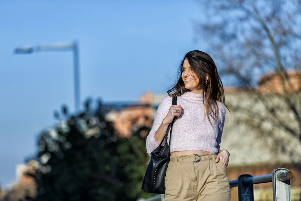 Happy smiling woman in casual wear going for a stroll in the city