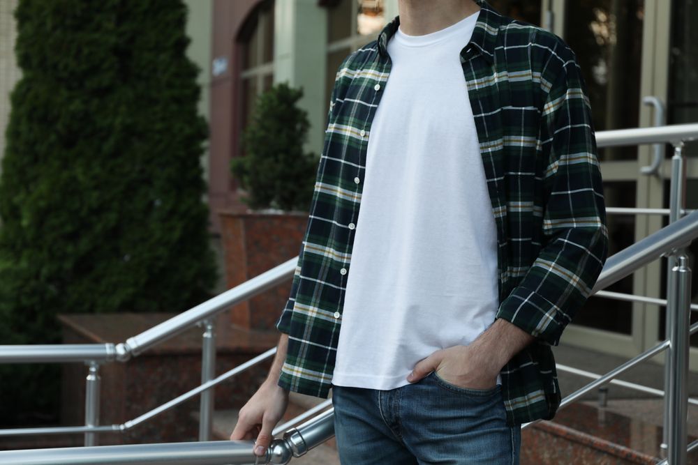 Men in blank t-shirt and green checkered shirt, space for text