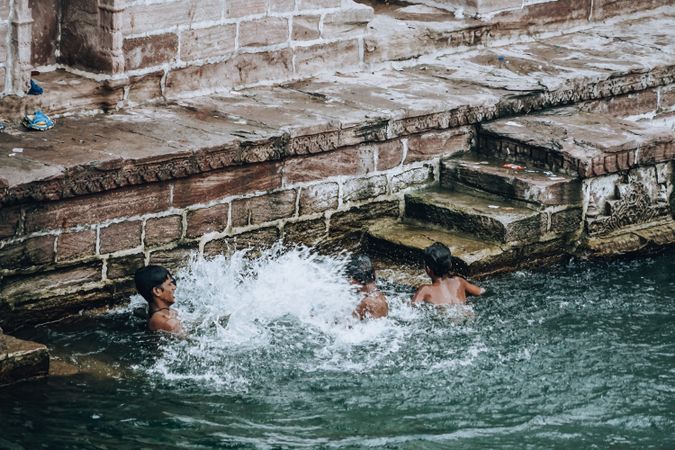 Group of boys swimming in river in Jodhpur, Rajasthan, India