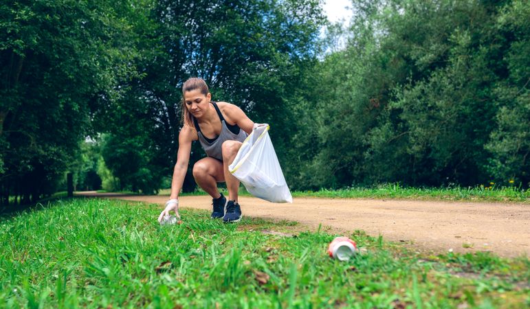 Woman with garbage bag doing plogging