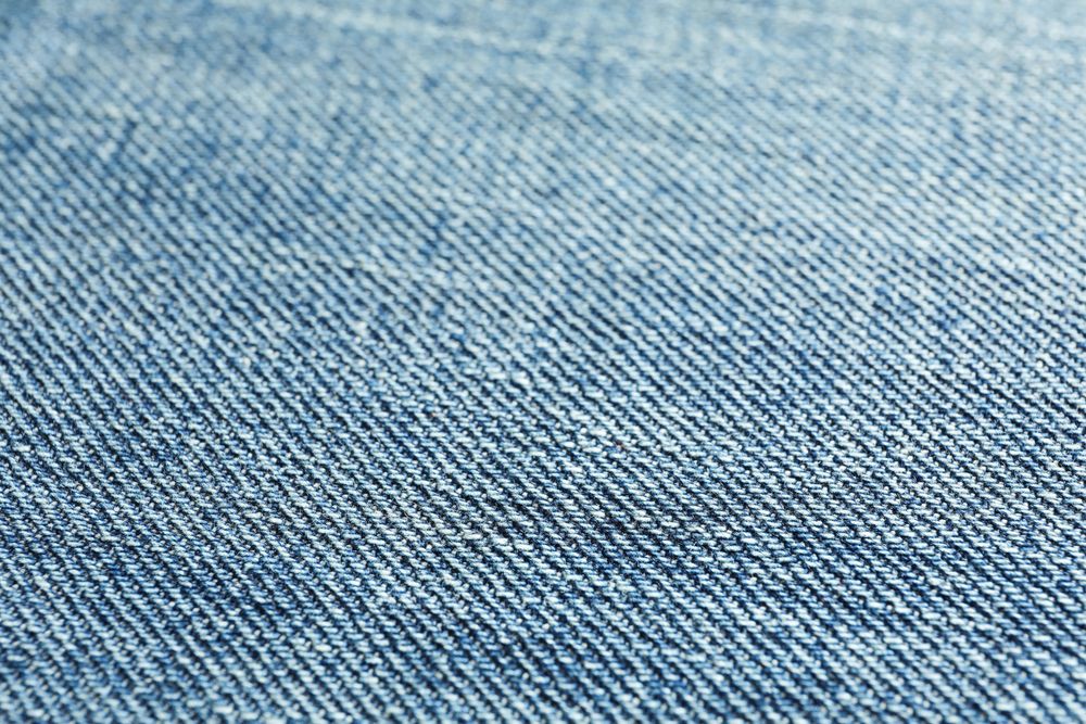 Texture of blue jeans as background, space for text