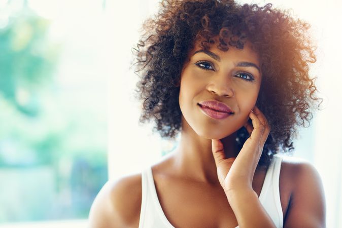 Portrait of female with curly hair with head tilted