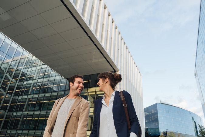 Businesspeople couple outside contemporary building