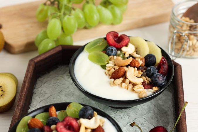 Yoghurt Bowl with Various Fresh Fruit, Cereal, and Peanuts