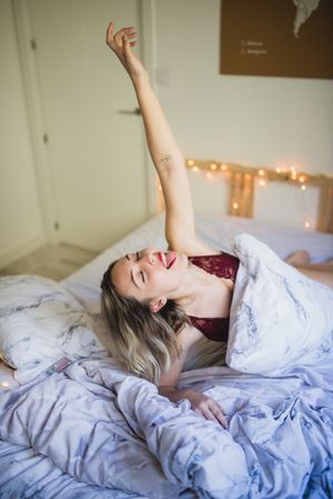 Woman lying in bed at home