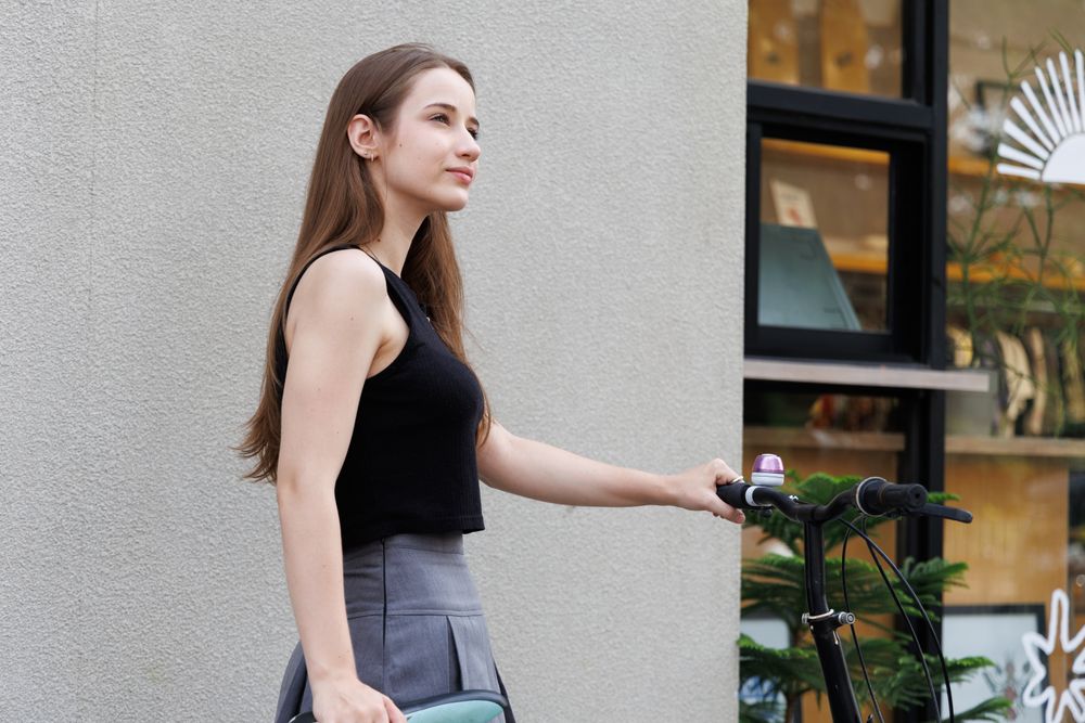 Woman walking with bicycle in the city