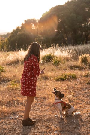 Woman with small friendly dog outdoors