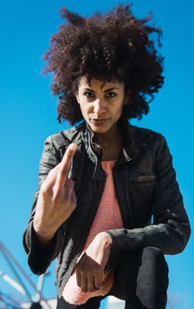 Woman with afro hair making insults.