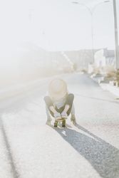 Stylish girl with skateboard on street