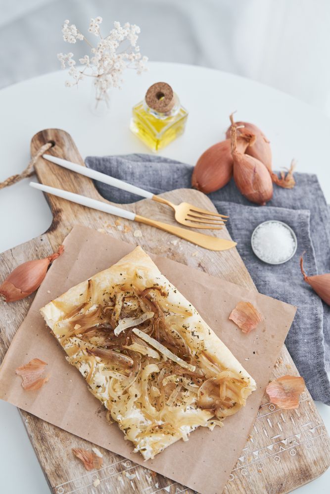 Delicious baked onion tart with cutlery