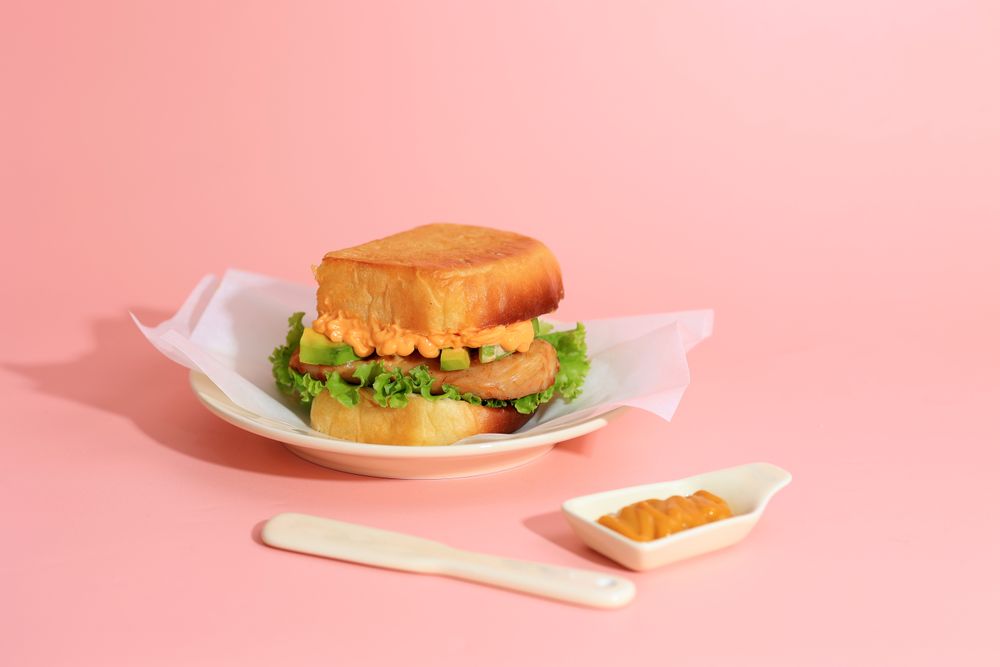 Chicken and Avocado Sandwich on Pink Background
