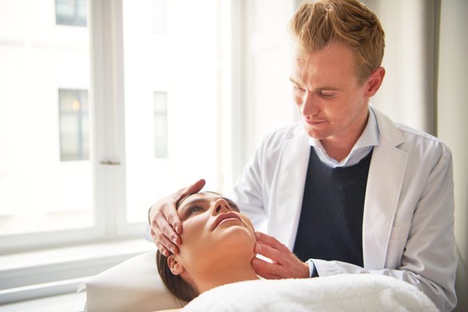 Woman on examination table with blonde male doctor