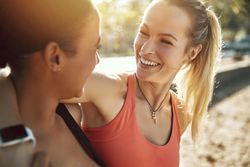 Close up of two smiling woman outside