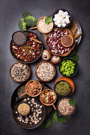 Bowls of healthy grains and vegetables, top view, vertical
