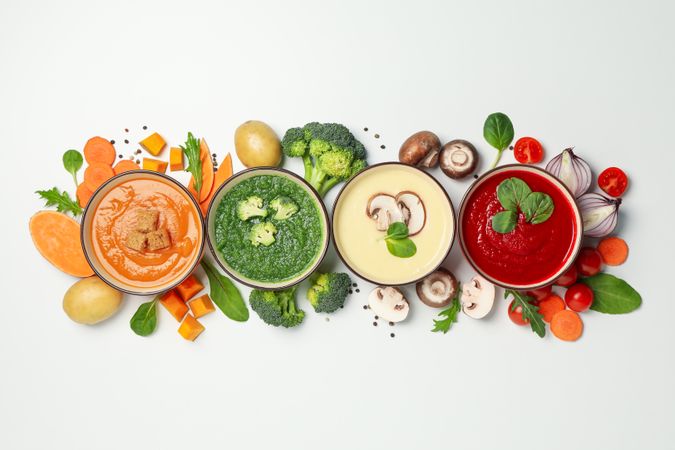 Line of multi-colored vegetable soups