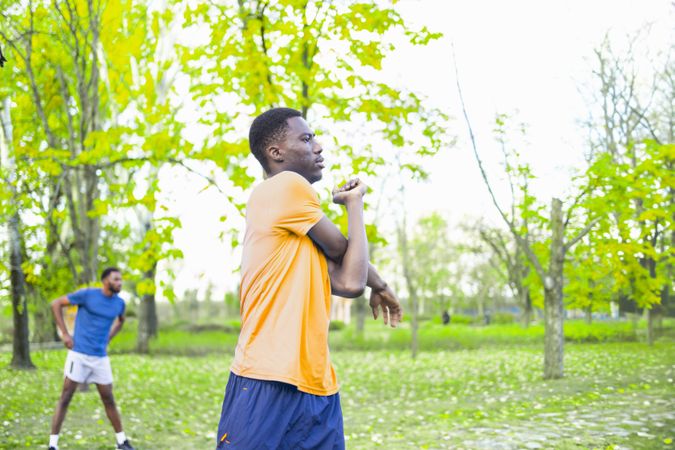 Black Man Stretching Arms in the Early Morning Spring Light.