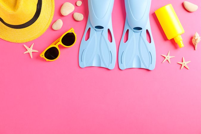 Sea vacation accessories on yellow background, top view