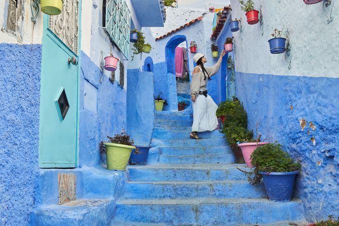 Woman on steps between ancient buildings