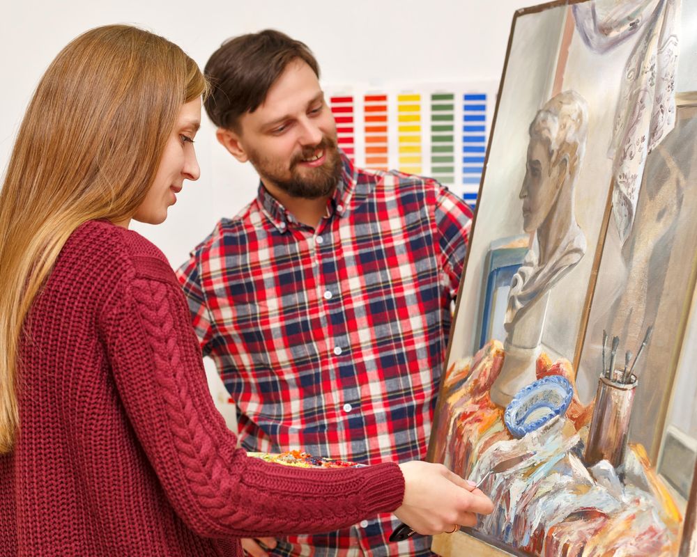 Female painter in front of image of a bust