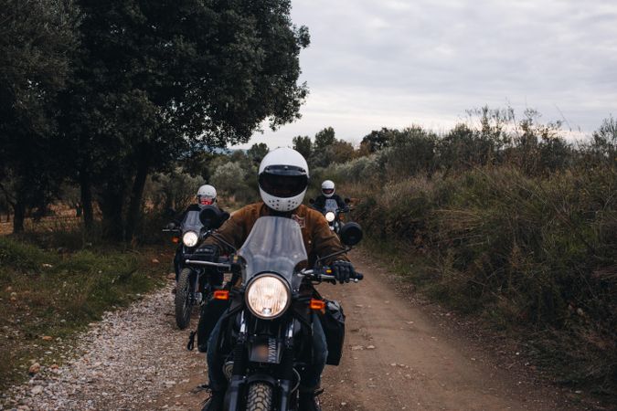 Friends riding together on country road